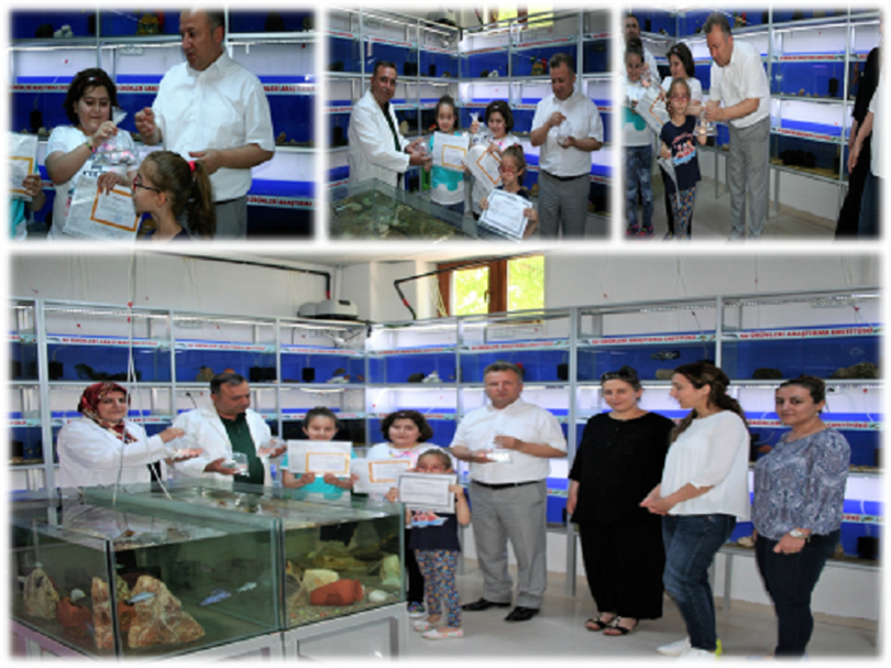 Institute Director Özkan ÖZBAY gave staff’s children who received the report card the ornamental fish produced in the aquarium as a gift